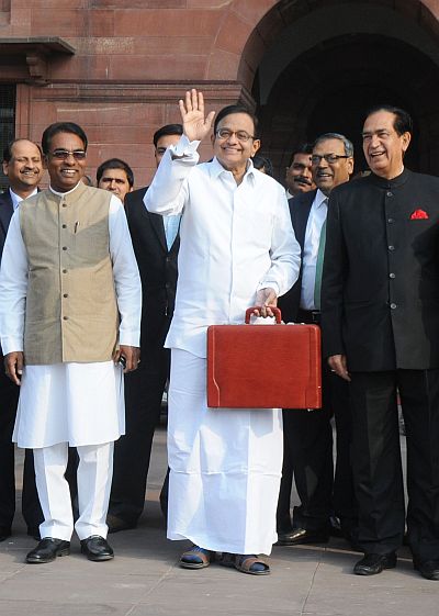 The Union Finance Minister, P. Chidambaram departs from North Block to Parliament House along with the Ministers of State for Finance, Namo Narain Meena (right) and Jesudasu Seelam to present the Interim Budget 2014-15, in New Delhi.