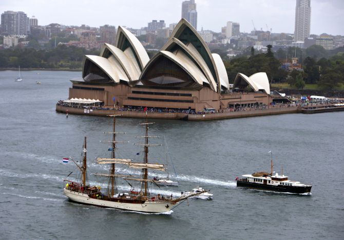 A tall ship sails past the Sydney Opera House as it enters Sydney Harbour.