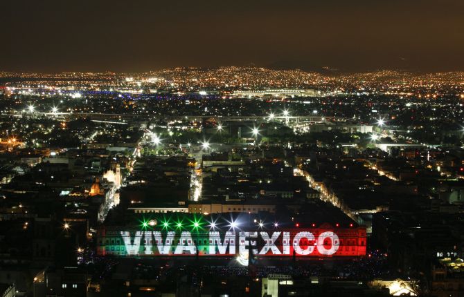 The national presidential palace is lit up in the colours of the Mexican flag during a sound and light show in Mexico City.