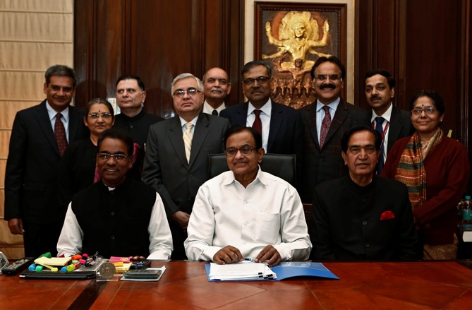 Finance Minister Palaniappan Chidambaram (C) sits with his staff before making the final touches to the interim budget for 2014/15 in New Delhi.