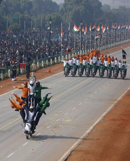 Indian soldiers perform a dare-devil show on their motorcycles during full dress rehearsal for the Republic Day parade in New Delhi.