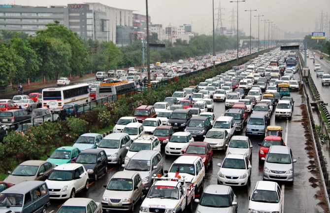 Heavy traffic moves along a busy road as it rains at the toll-gates at Gurgaon on the outskirts of New Delhi.