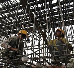 Labourers work at a flyover construction site in Mumbai. Photograph: Danish Siddiqui/Reuters 
