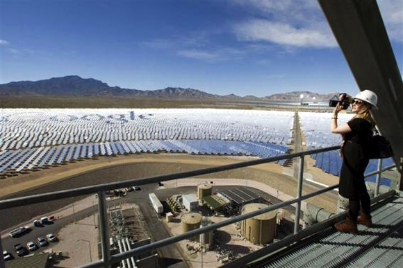 Katie Kukulka, an information officer with the California Energy Commission, takes photos during a tour of the Ivanpah Solar Electric Generating System in the Mojave Desert near the California-Nevada.