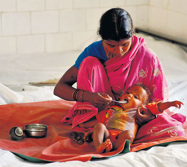 A woman feeds her malnourished child in Sheopur district. Most welfare programmes in India are corruption-ridden and poorly run.
