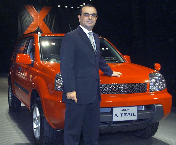 This file photograph shows Nissan Motor President Carlos Ghosn posing with Nissan's X-Trail SUV.