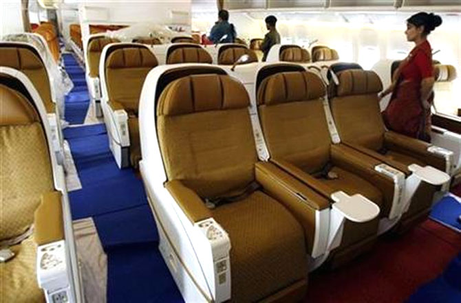 People walk inside the business class section of Air India's Boeing 777-200 LR aircraft.