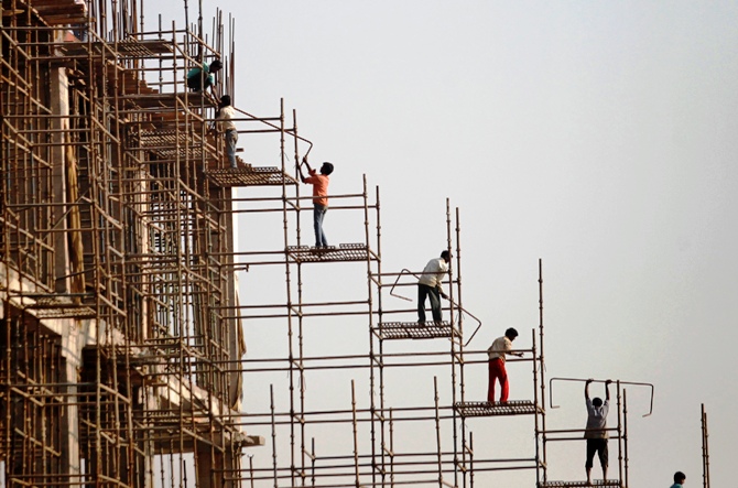 Labourers work at the construction site of a commercial complex in New Delhi.