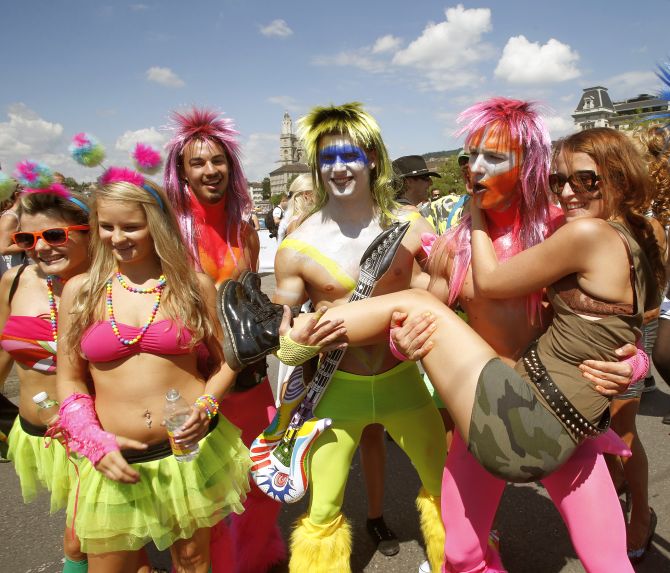 Revellers pose during the 22nd Street Parade dance music event on the Quaibruecke bridge in Zurich.