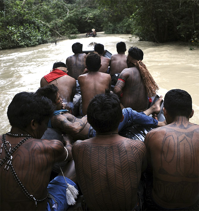 Munduruku Indian warriors navigate the Das Tropas river, a tributary of the Tapajos and Amazon rivers, as they search for illegal gold mines and miners in their territory in western Para state.