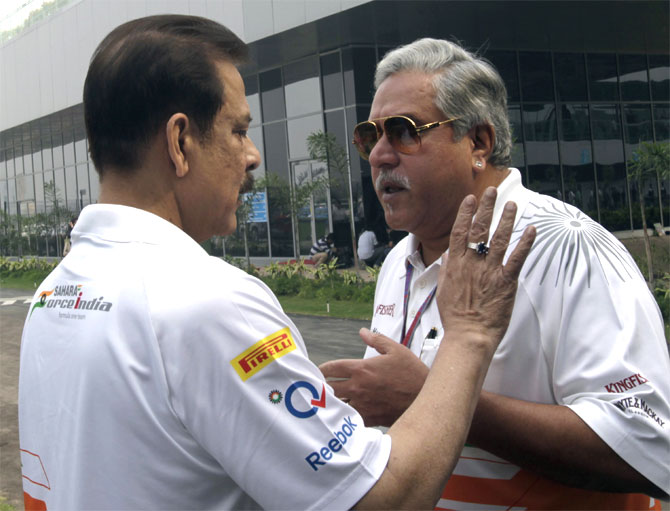 Force India team principal Vijay Mallya (R) talks to Sahara Group chairman Subrata Roy in the paddock before the Indian F1 Grand Prix at the Buddh International Circuit in Greater Noida, on the outskirts of New Delhi.