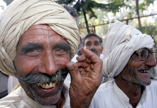 Farmers smile at a gathering held after the announcement of the annual budget.