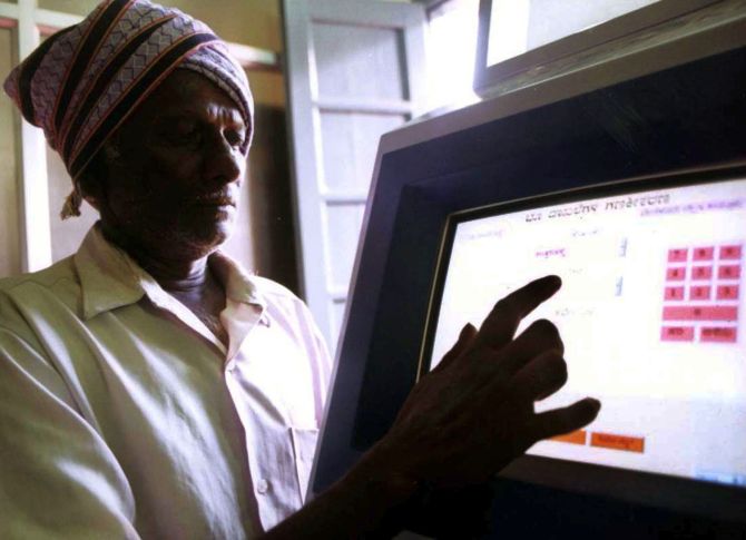 An Indian farmer uses a computer to check land-records