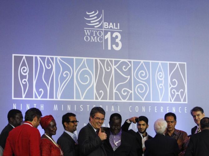 Director-General Roberto Azevedo gives a thumbs-up as he greets delegates after the closing ceremony of the ninth World Trade Organization (WTO) Ministerial Conference in Nusa Dua, on the Indonesian resort island of Bali.