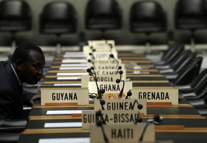 A delegate waits for the opening of a session of the Trade Negotiation Committee at the World Trade Organization (WTO) in Geneva.