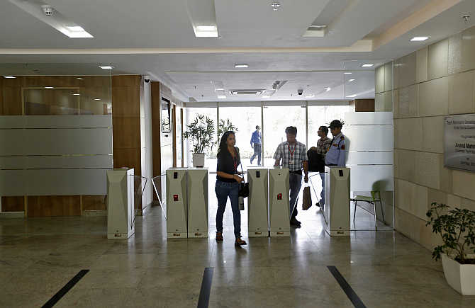 Employees arrive for work at Tech Mahindra office building in Noida.