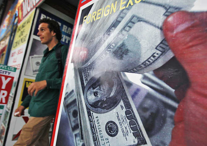 A tourist leaves a currency exchange shop at an arcade in New Delhi.