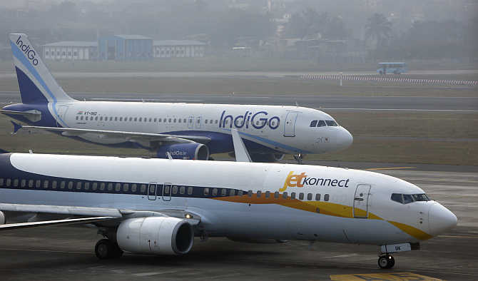 An IndiGo Airlines Airbust A320 aircraft and JetKonnect Boeing 737 aircraft taxi at Mumbai's Chhatrapathi Shivaji International Airport.