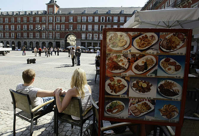 People sit in a restaurant in Madrid's central Plaza Mayor, Spain.