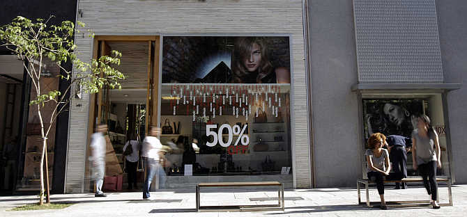 Consumers walk along Oscar Freire street, Sao Paulo's version of Rodeo Drive in Beverly Hills, in Sao Paulo, Brazil.