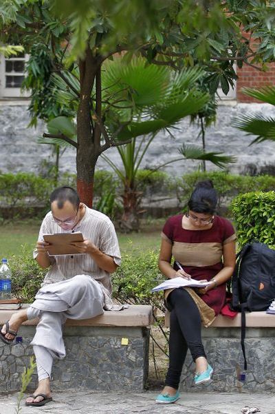 Indian students study inside the Delhi University campus.