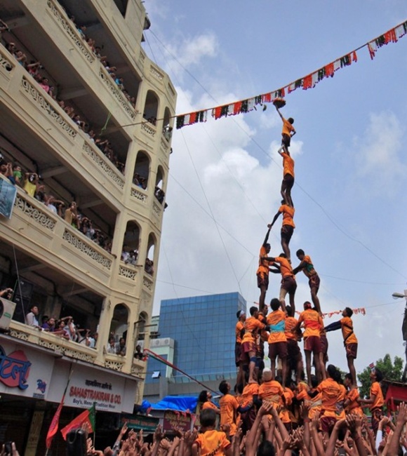 Devotees form a human pyramid to break a clay pot containing curd during the celebrations to mark the Hindu festival of Janmashtami in Mumbai.
