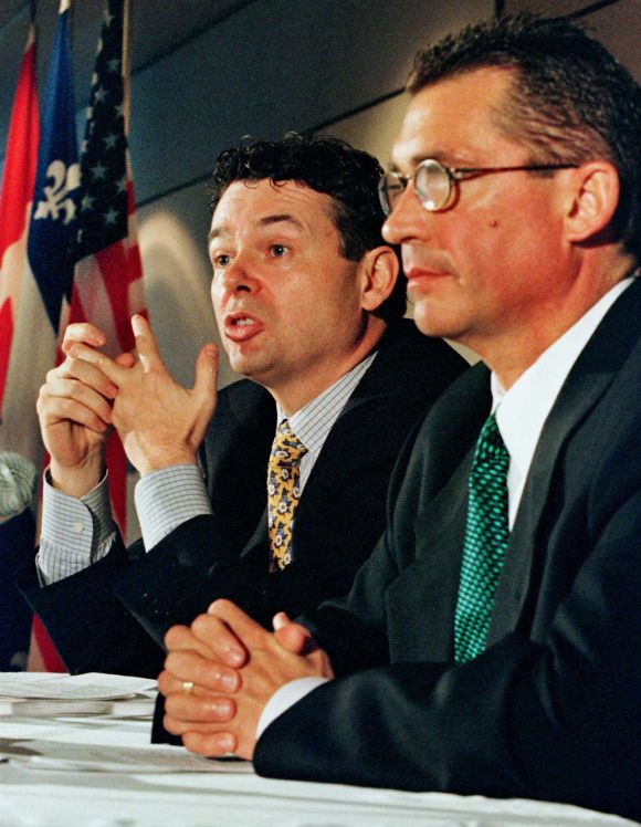 Charles Sirois (L) of Teleglobe Inc., and Kenny Troutt of Excel Communications Inc.