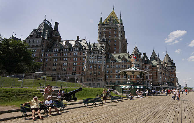People walk near the Chateau Frontenac in Quebec City, Canada.