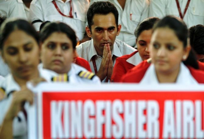Employees of Kingfisher Airlines take part in a protest against the company in New Delhi.