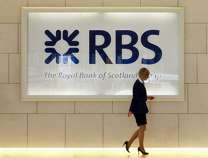 A worker walks in the foyer of a Royal Bank of Scotland office in the City of London.
