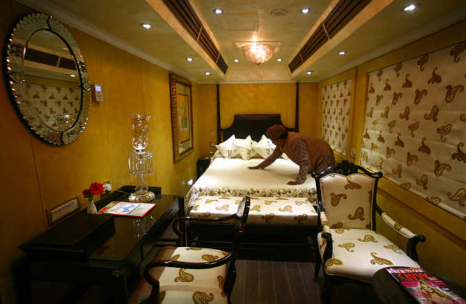 An attendant works inside the super deluxe 'Taj Mahal' suite of the luxury train 'Royal Rajasthan on Wheels' in Haryana.