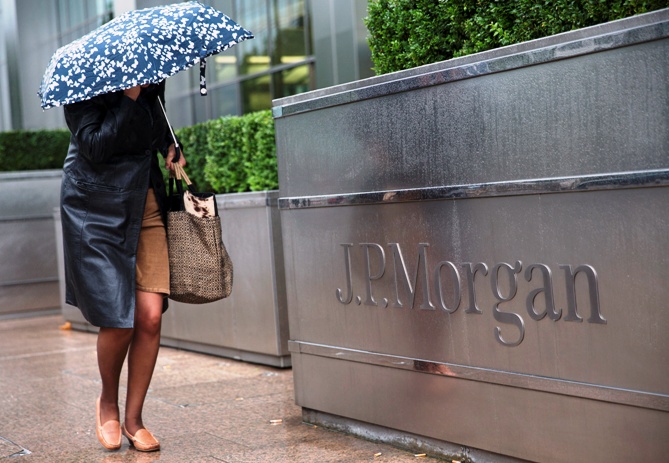 A pedestrian walks past the Canary Wharf offices of JP Morgan in London.