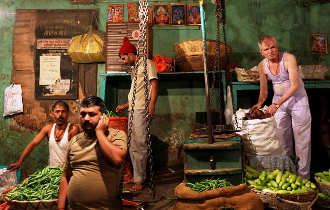 Vendors arrange vegetables at their stalls at a wholesale market in Mumbai.