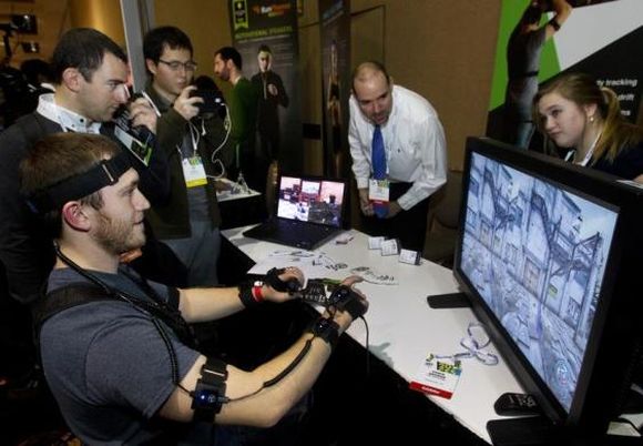 YEI Technology's Chris George plays a computer game with PrioVR, a virtual reality gaming accessory.