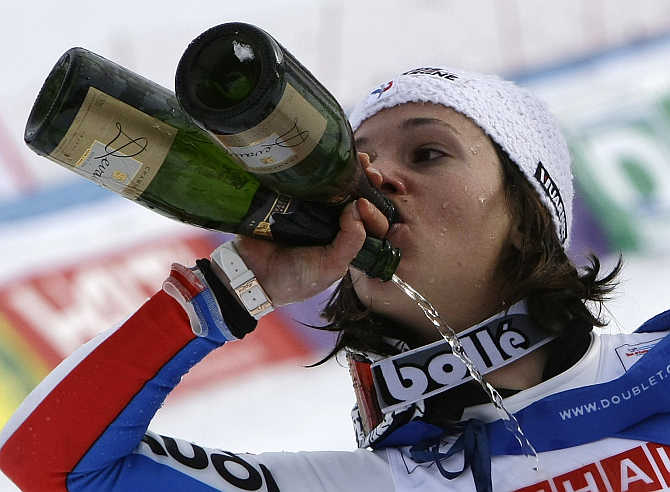 Marie Marchand-Arvier tries to drink at once from two different bottles of champagne after winning the silver medal during the women's Super G race at the Alpine Skiing World Championships in the French resort of Val d'Isere.
