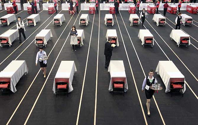 Contestants race with trays holding beer bottles and glasses during a tray carrying competition in Taipei, Taiwan.