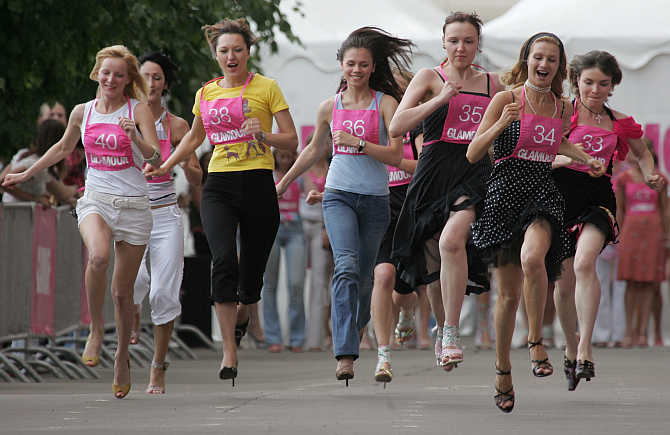 Women compete in a high-heel sprint in Moscow, Russia.