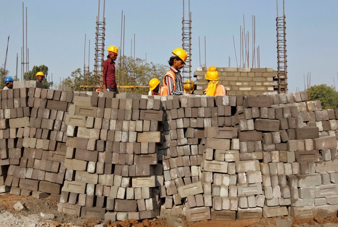 Labourers work at the construction site of an educational institute in Gujarat.