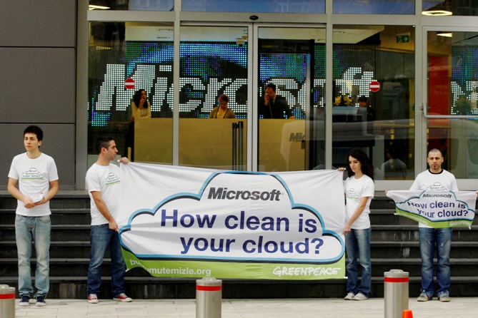 Greenpeace activists hold a banner during a demonstration against what they say are energy choices made by Microsoft.