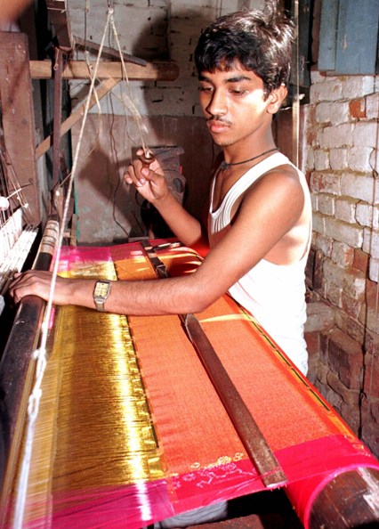 A weaver works on a silk saree.