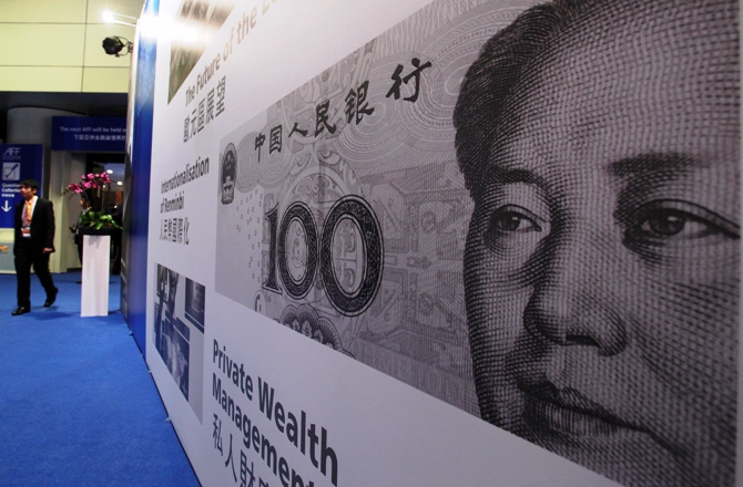 An enlarged printout of a Renminbi banknote is displayed at the Asian Financial Forum in Hong Kong January 14, 2013.