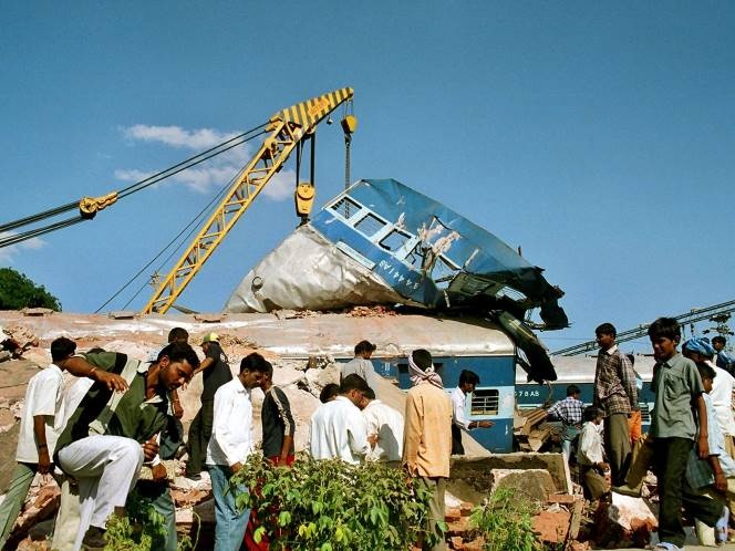 Onlookers move near the wreckage of a train following a deadly accident in Datia town, about 400 km (250 miles) north of the Bhopal.