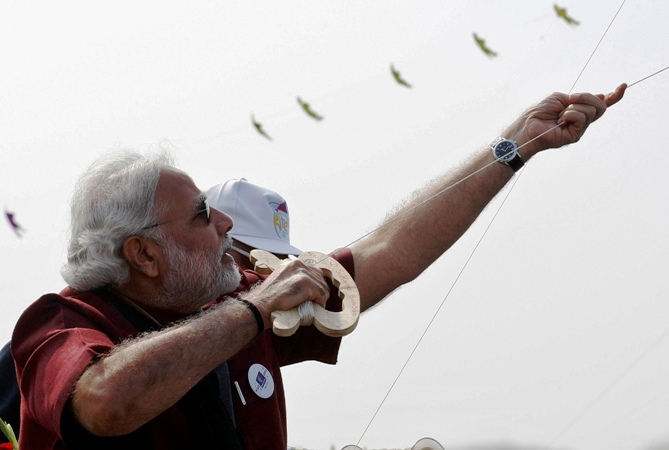 Narendra Modi, prime ministerial candidate for India's main opposition BharatiNarendra Modi flies a kite at the international kite festival in Ahmedabad January 12, 2014.