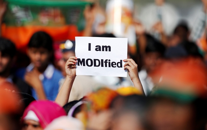A supporter of Narendra Modi holds a placard during a rally being addressed by him in Mumbai December 22, 2013.