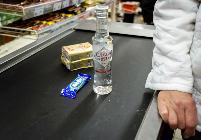 A customer waits in a queue to buy vodka and chocolate in the small Ukrainian town of Pustomyty, near the western city Lviv.