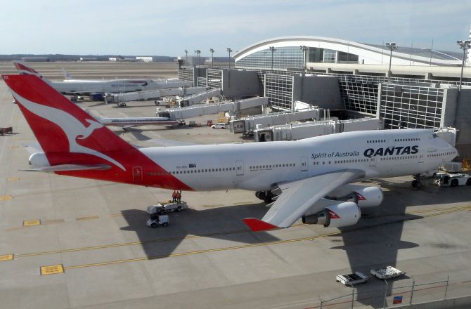The Boeing 747-400ER operated by Qantas parked at Terminal D of Dallas/Fort Worth International Airport.
