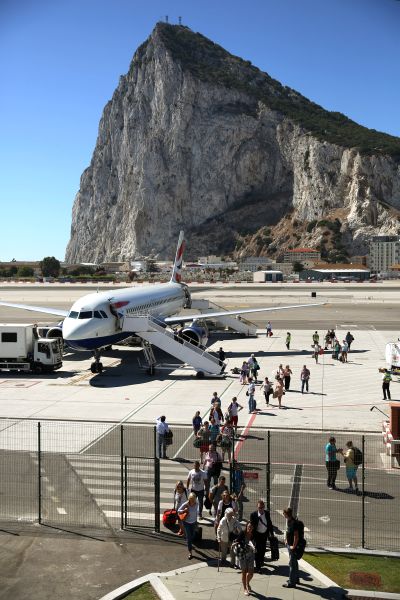Passengers disembark a flight shortly after landing at Gibraltar International Airport.