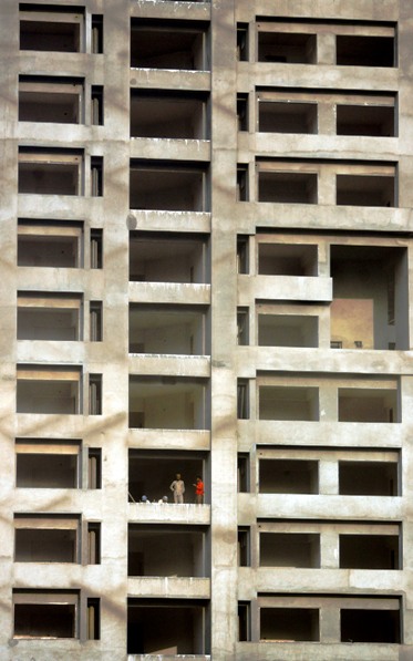 Workers stand in a building under construction in Mumbai.