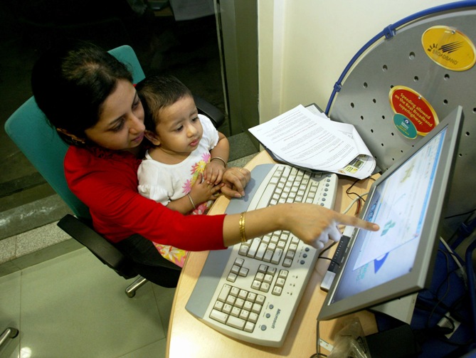 This file photograph shows Sangeeta Dutta and daughter Anushna sit at a high-speed broadband Internet cafe in Kolkata.