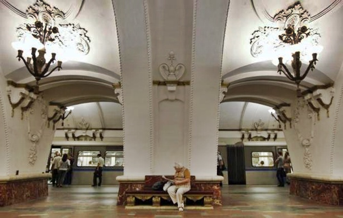 A woman sits on a bench at Prospekt Mira metro station in Moscow.